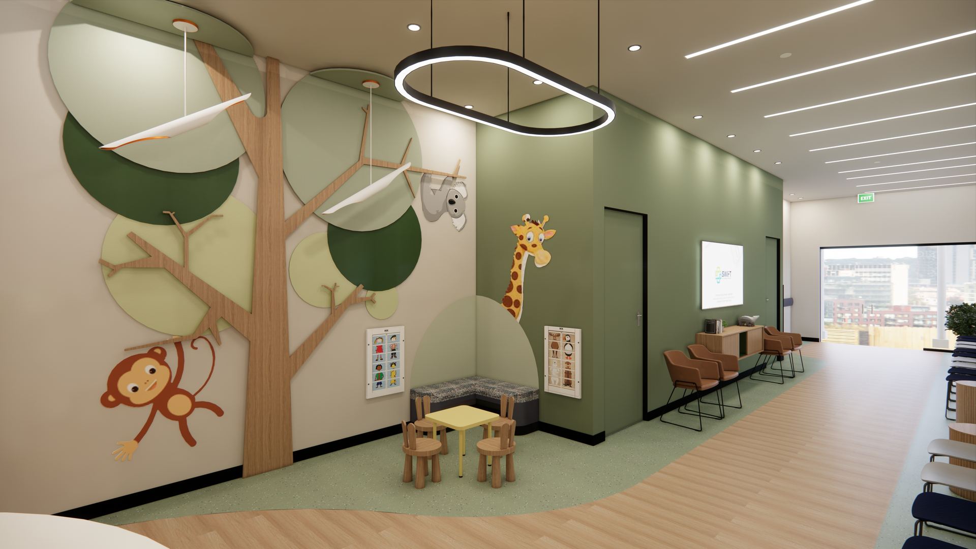The kids and family waiting area, with a tree mural, giraffe and small play table